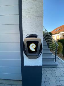 a suitcase with a logo on the side of a building at Apartment Keuerleber in Holzmaden