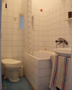 a bathroom with a toilet and a tub and a sink at Apartments by the sea Povlja, Brac - 710 in Povlja