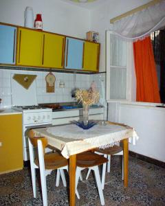 a kitchen with a table with a vase of flowers on it at Apartments by the sea Povlja, Brac - 710 in Povlja
