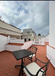 d'une terrasse sur le toit avec une table et des chaises. dans l'établissement Apartamento La Canela, à Nerja