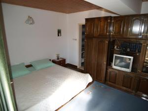 a bedroom with a bed and a tv in it at Apartments by the sea Sutivan, Brac - 719 in Sutivan