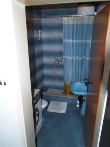 a blue bathroom with a toilet and a shower at Apartments by the sea Sutivan, Brac - 719 in Sutivan