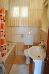 a small bathroom with a toilet and a sink at Apartments by the sea Milna, Brac - 733 in Milna