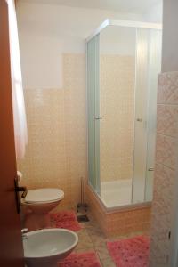 a bathroom with a shower and a toilet and a sink at Apartments by the sea Milna, Brac - 733 in Milna
