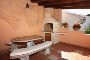 a patio with a bench and a brick oven at Apartments with parking space Sutivan, Brac - 745 in Sutivan +25 photos