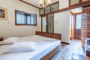 a bedroom with a large bed and a window at Apartments by the sea Sumartin, Brac - 758 in Sumartin