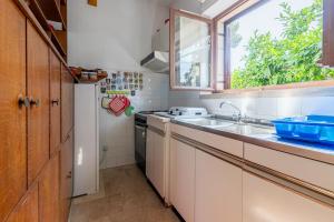 a kitchen with a sink and a window at Apartments by the sea Sumartin, Brac - 758 in Sumartin