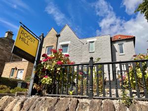 a house with a sign in front of it at Roost Hill - Free Parking Zone in Edinburgh +12 photos