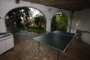 a ping pong table in a kitchen with an outdoor table at Apartments by the sea Maslinica, Solta - 772 in Grohote
