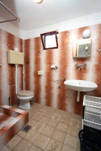 a bathroom with a toilet and a sink at Apartments by the sea Stomorska, Solta - 784 in Stomorska