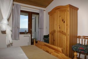 a bedroom with a bed and a wooden cabinet at Apartment Duce 945b in Duće