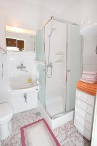 a bathroom with a shower and a toilet and a sink at Apartments by the sea Slatine, Ciovo - 972 in Trogir