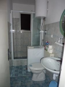 a bathroom with a toilet and a sink at Apartments by the sea Seget Vranjica, Trogir - 976 in Seget Vranjica