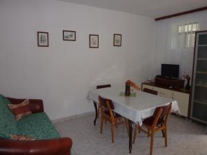 a living room with a table and chairs and a couch at Apartments by the sea Seget Vranjica, Trogir - 976 in Seget Vranjica