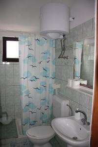 a bathroom with a toilet and a sink and a shower curtain at Apartments and rooms by the sea Zaklopatica, Lastovo - 994 in Lastovo +39 photos
