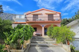 a pink house with stairs in front of it at Apartments with parking space Stanici, Omis - 1027 in Čelina