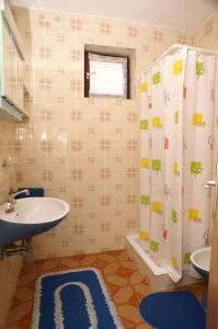 a bathroom with a sink and a toilet and a shower at Apartments by the sea Seget Vranjica, Trogir - 1050 in Seget Vranjica