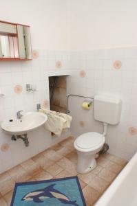 a bathroom with a toilet and a sink at Apartment Seget Vranjica 1050b in Seget Vranjica