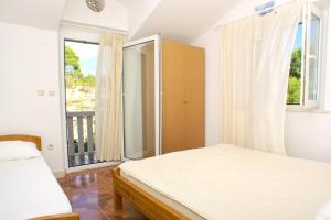 a bedroom with a bed and a large window at Seaside apartments with a swimming pool Puntinak, Brac - 769 in Selca