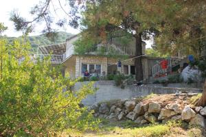 a house with a tree in front of it at Double Room Lucica 990a in Lastovo