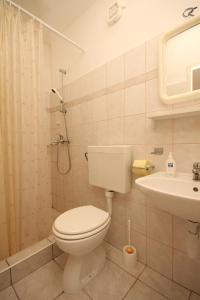 a bathroom with a toilet and a sink and a shower at Twin Room Lucica 990c in Lastovo