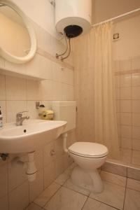 a bathroom with a toilet and a sink and a mirror at Twin Room Lucica 990b in Lastovo
