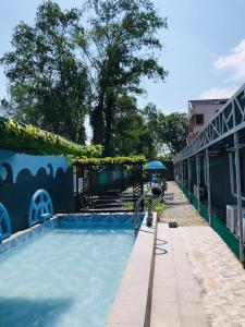 a pool with a slide in front of a building at RD Legend Hotel in Port Dickson +27 photos