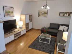 a living room with a couch and a tv at Apartments by the sea Postira, Brac - 706 in Postira