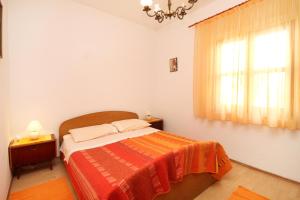 a bedroom with a bed and a window at Apartments by the sea Tkon, Pasman - 822 in Tkon