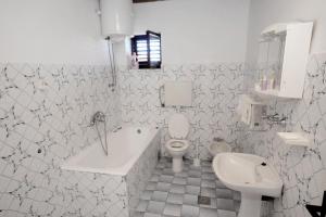 a white bathroom with a toilet and a sink at Apartments by the sea Privlaka, Zadar - 666 in Privlaka