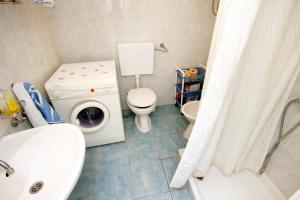 a bathroom with a washing machine and a toilet at Apartments by the sea Tkon, Pasman - 822 in Tkon