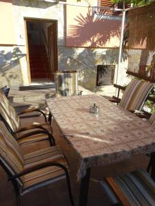 a wooden table and chairs on a patio at Apartment Biograd na Moru 860c in Biograd na Moru