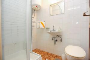a bathroom with a toilet and a sink and a shower at Apartments with parking space Marusici, Omis - 954 in Mimice +15 photos