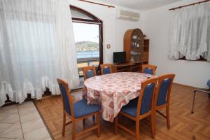 a dining room with a table and chairs and a window at Apartment Kali 834a in Kali