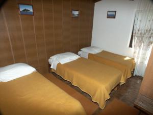 a room with three beds in a room at Secluded fisherman's cottage Cove Dragnjevica - Telascica, Dugi otok - 902 in Sali