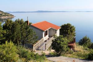 a house on the edge of a body of water at Apartments by the sea Savar, Dugi otok - 892 in Brbinj