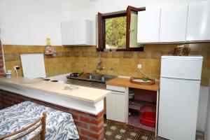 a kitchen with white cabinets and a sink and a counter at Apartments by the sea Savar, Dugi otok - 892 in Brbinj