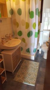 a bathroom with a sink and a shower curtain at Apartment Sali 890b in Sali