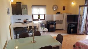 a kitchen and living room with a dining room table and a kitchen and a kitchen at Apartment Sali 890e in Sali