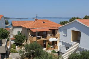 a view of a house with an orange roof at Apartments with a parking space Sali, Dugi otok - 872 in Sali