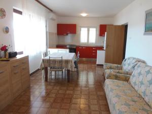 a kitchen and a living room with a table and a couch at Seaside holiday house Veli Rat, Dugi otok - 875 in Veli Rat