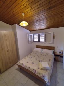 sypialnia z łóżkiem i drewnianym sufitem w obiekcie Secluded fisherman's cottage Cove Jaz - Telascica, Dugi otok - 876 w mieście Sali