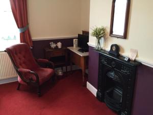 a room with a chair and a desk with a computer at The Ship Inn in Fordingbridge