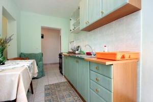 a kitchen with blue cabinets and an orange sink at Apartment Zaglav 878a in Zaglav