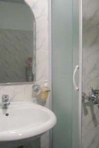 a bathroom with a sink and a mirror at Apartments with a parking space Vodice - 927 in Vodice