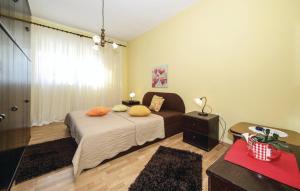 a bedroom with a bed with pillows on it at Apartments by the sea Brodarica, Sibenik - 921 in Brodarica