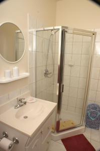 a white bathroom with a shower and a sink at Apartments and rooms with parking space Sumartin, Brac - 757 in Sumartin