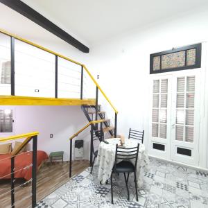 a dining room with a staircase and a table and chairs at Luna de Mandalas in Buenos Aires