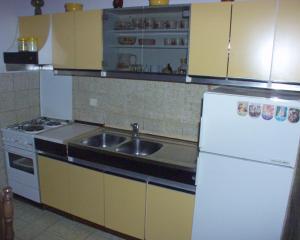 a kitchen with a sink and a white refrigerator at Apartments by the sea Postira, Brac - 738 in Postira
