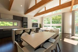 a kitchen and dining room with a table and chairs at Annupuri Onsen Chalet in Niseko